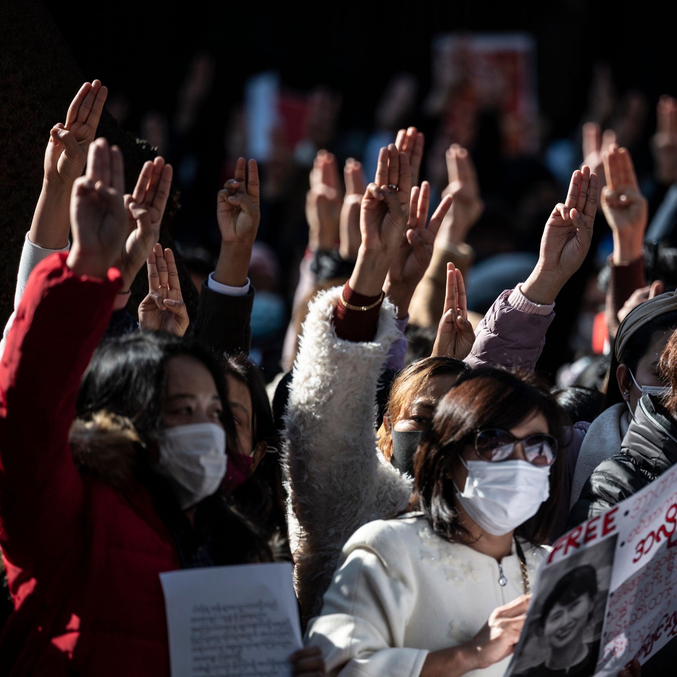 Myanmar activists gesture three-finger salutes as they protest outside the Myanmar embassy in Tokyo on February 7, 2021. Photo by PHILIP FONG/AFP via Getty Images