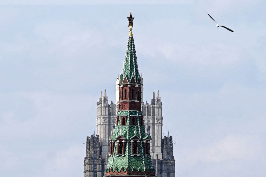 A seagull flies past one of the Kremlin towers (front) and the Russian Foreign Ministry headquarters in Moscow