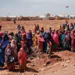 People wait for food distributions and health services at a camp for internally displaced persons (IDPs) in Baidoa, Somalia, on February 14, 2022.
