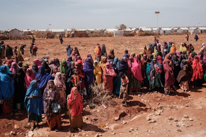People wait for food distributions and health services at a camp for internally displaced persons (IDPs) in Baidoa, Somalia, on February 14, 2022.
