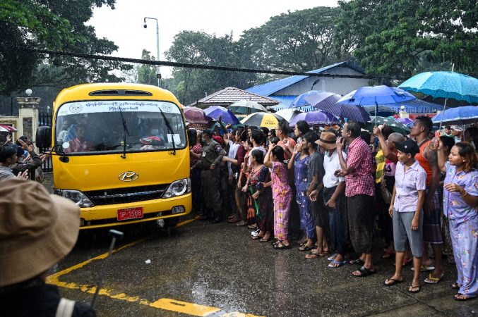 Relatives gather around a bus carrying prisoners being released outside the Insein prison in Yangon on November 17, 2022. (Photo by STR/AFP via Getty Images)