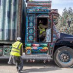 Afghan custom workers check a cargo truck as it arrives from Pakistan at the Afghanistan-Pakistan Torkham border post in Nangarhar province (February 2023). Photo by WAKIL KOHSAR / AFP via Getty Images