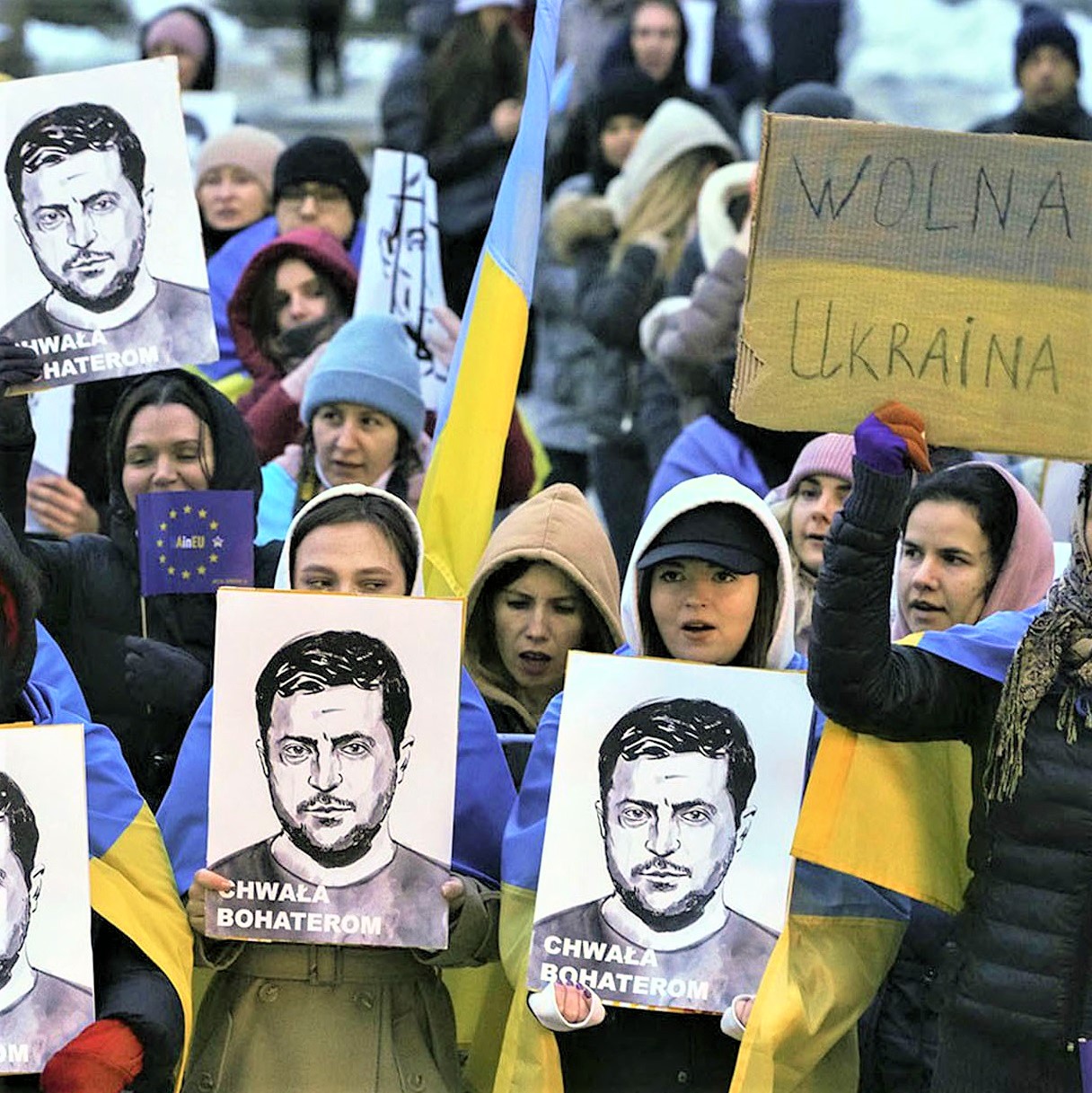People hold portraits of Ukrainian President Volodymyr Zelenskyy during an anti-war rally in front of the Palace of Culture and Science in Warsaw, Poland, Saturday, April 2022. Image: AP Photo / Czarek Sokolowski