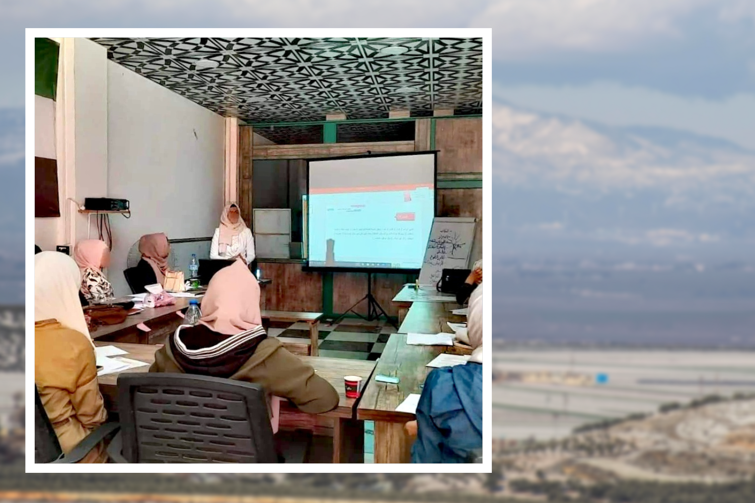 Photo of research group participants with view of northern Syria countryside in background