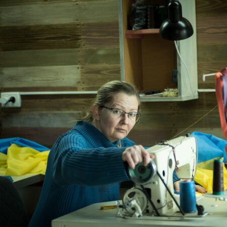 volunteer sews a national flag at a volunteer center in Zaporizhzhia, Ukraine. February 28, 2022.