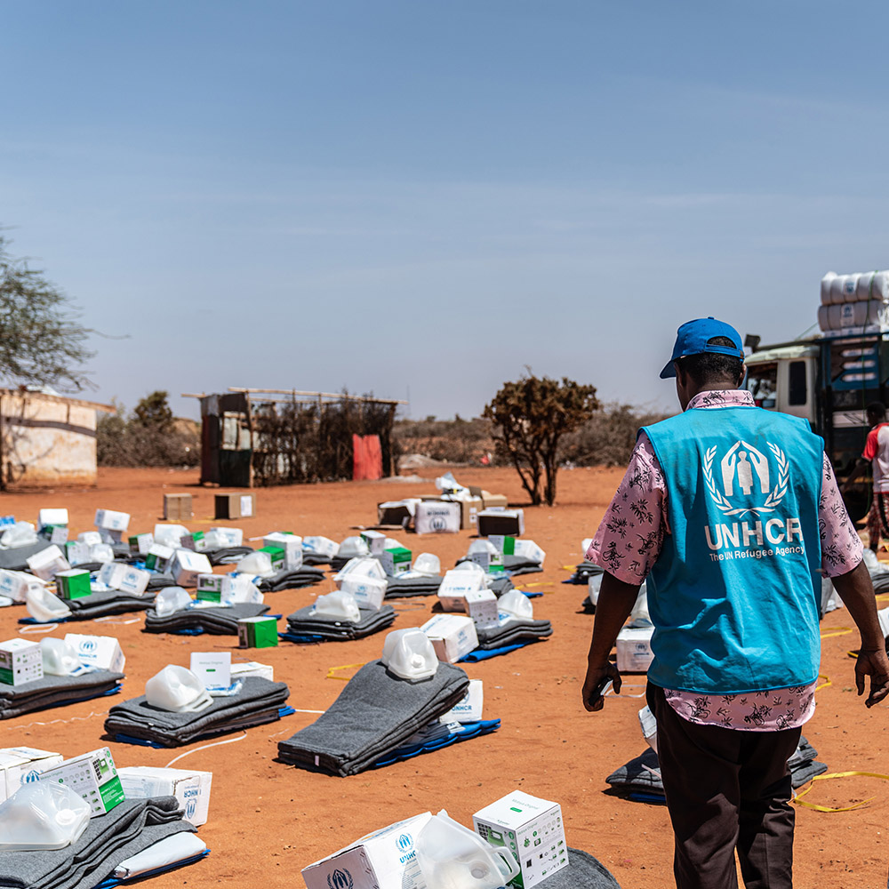A UN aid worker organises kits at an IDP camp