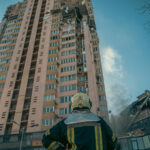 A firefighter standing in front of a building