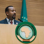 Prime Minister Abiy Ahmed stands behind an AU lectern