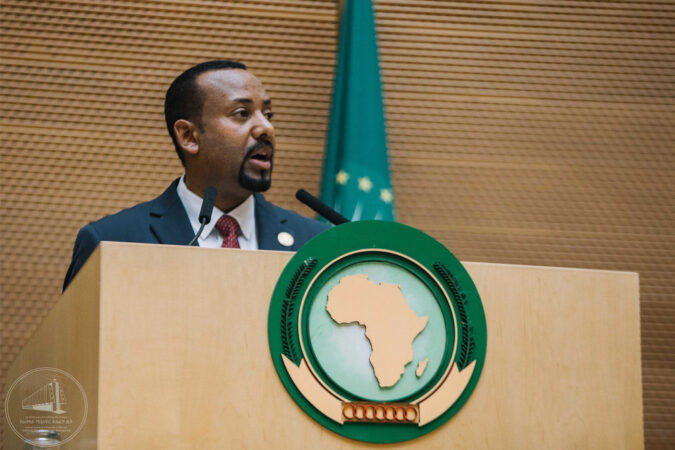 Prime Minister Abiy Ahmed stands behind an AU lectern
