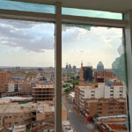 A view of the city of Khartoum through smashed windows