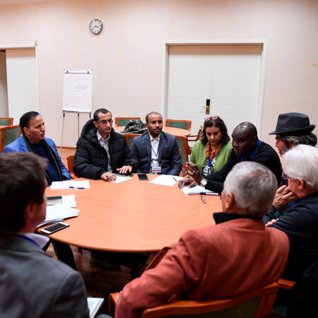Members of a Yemeni government's delegation take part in a work group with rebel delegation members and UN special envoy to Yemen