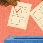 A close up of a hand placing a vote in a box