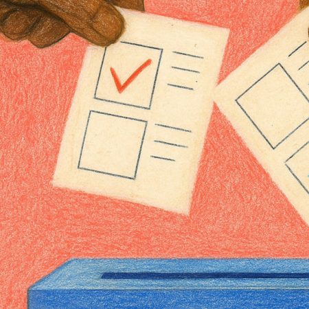 A close up of a hand placing a vote in a box