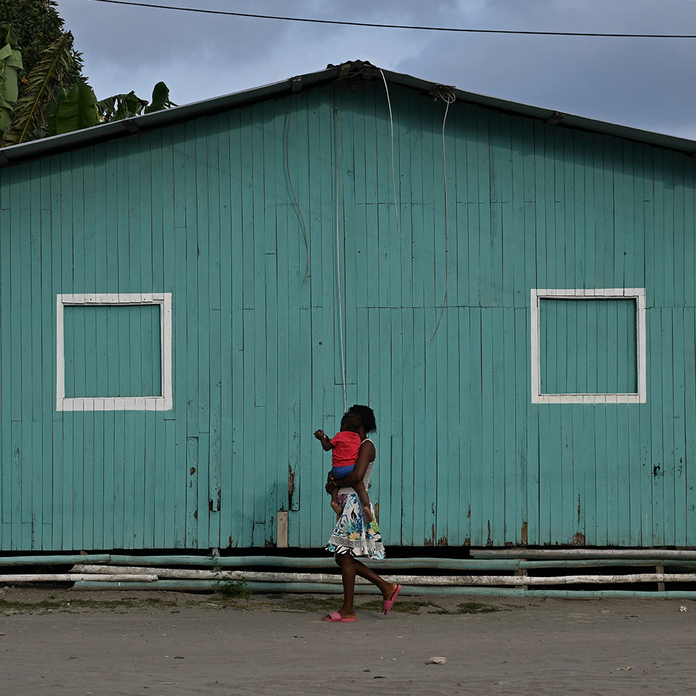 A woman walks at the Bajito neighborhood in the port city of Tumaco, department of Narino, Colombia