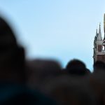 A crowd of people in front of a clock in Moscow
