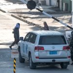 Taliban security personnel check a UN vehicle