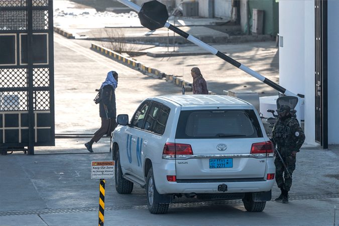 Taliban security personnel check a UN vehicle