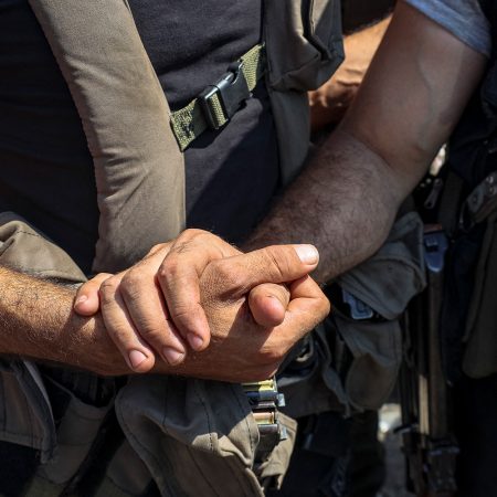 Two Syrian men shake hands