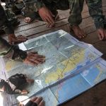 Soldiers look at a map of Myanmar