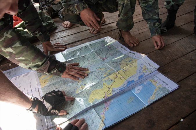 Soldiers look at a map of Myanmar