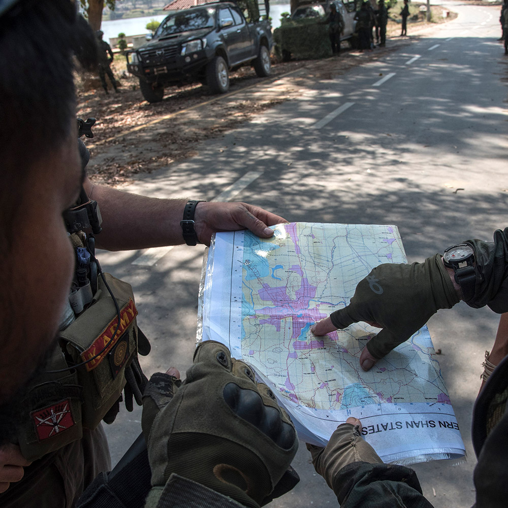 Soldiers examine a map of Myanmar