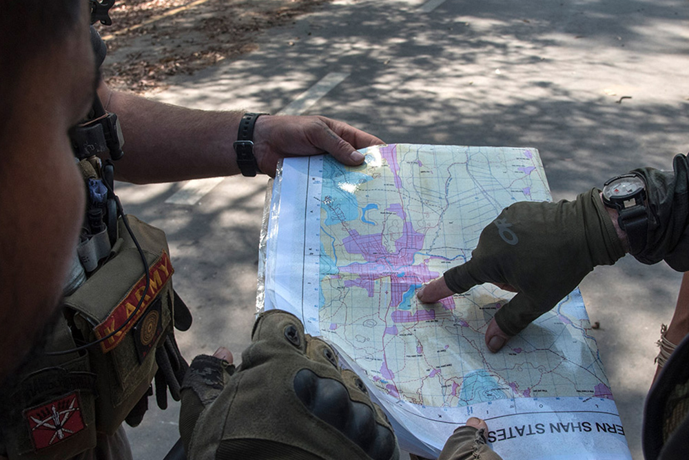 Soldiers examine a map of Myanmar