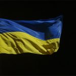 The yellow and blue flag of Ukraine flutters on a flagpole