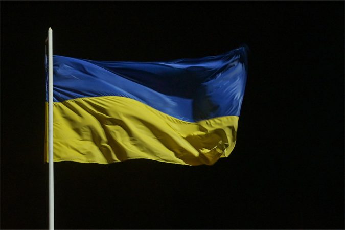 The yellow and blue flag of Ukraine flutters on a flagpole